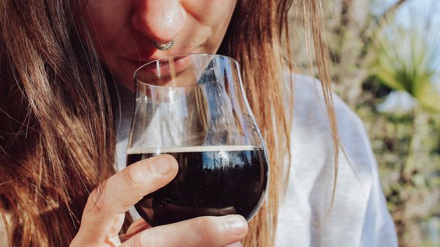 Woman with a glass of dark beer Stout 