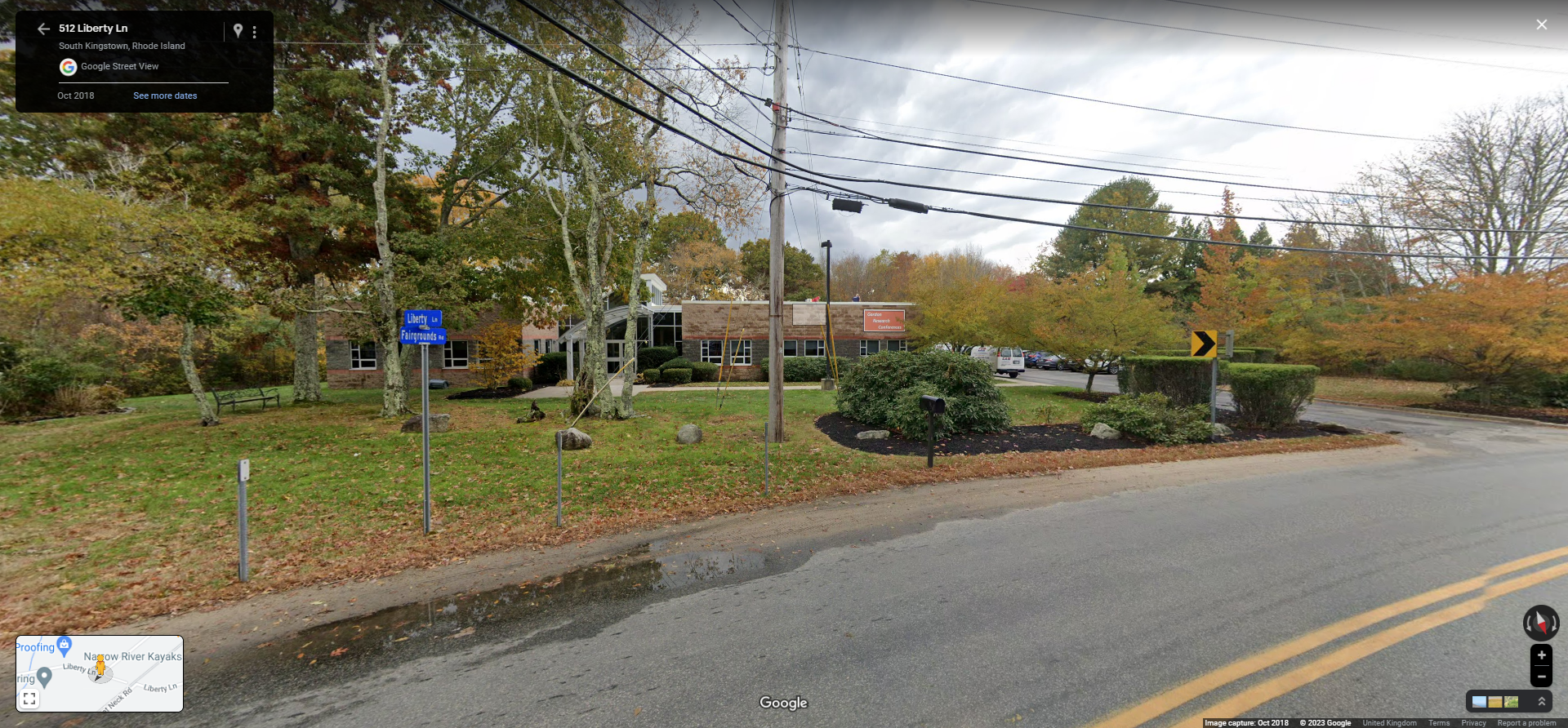 A red brick building by the side of a road. 